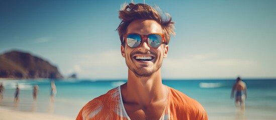 Smiling young man wearing sunglasses by the sea conveying message of vacations awareness and protection - Powered by Adobe