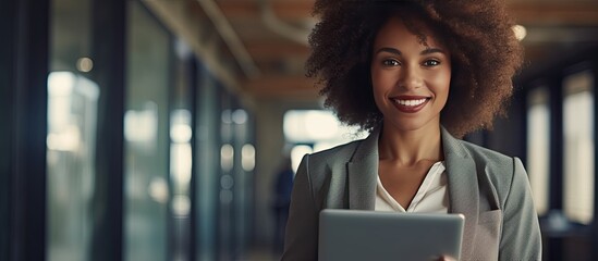 African American businesswoman using digital tablet smiling at camera