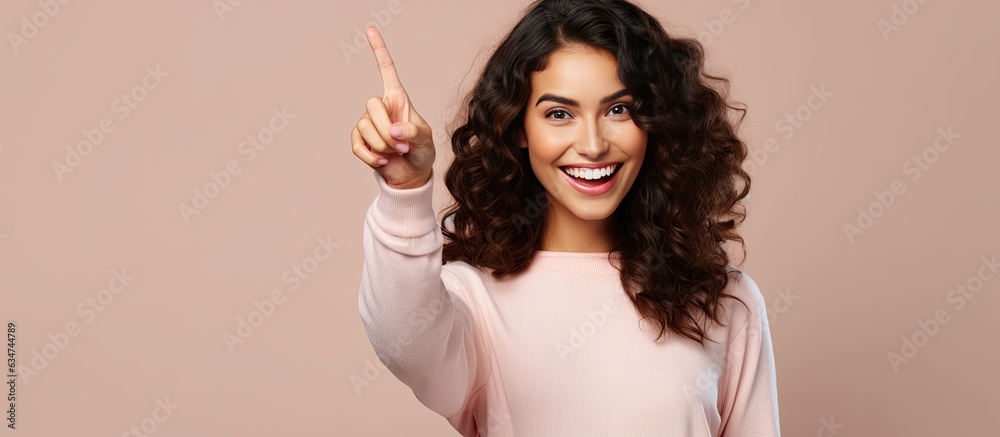 Poster attractive woman happily pointing to the side and up with object in open area