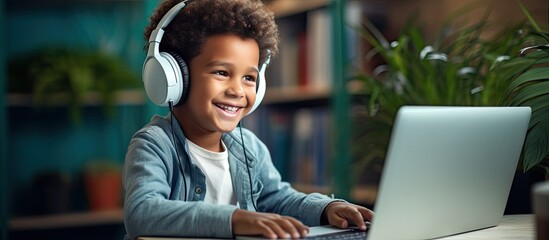Childhood student studying at home with headphones typing on laptop for online e learning