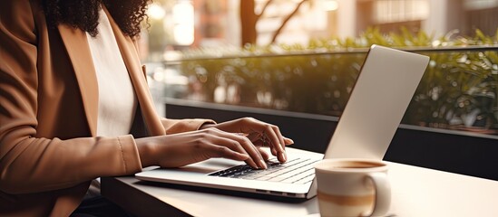 Biracial woman multitasking with laptop and tablet working from home Remote work technology and modern lifestyle