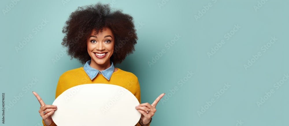 Poster excited african woman holding painter palette pointing aside with open palms showcasing copy space f