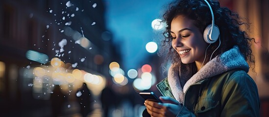 A young woman enjoying the city nightlife with music and her smartphone