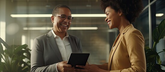 African American businesswoman using digital tablet smiling at camera