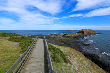 Beautiful blue sky with clouds at Phillips Island, Victoria Australia. Wooden broadwalk to seaside...
