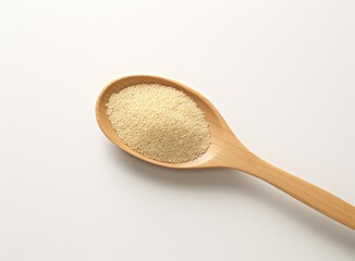 Uncooked white quinoa seeds, in the wooden bowl, isolated on pure white background, top view.