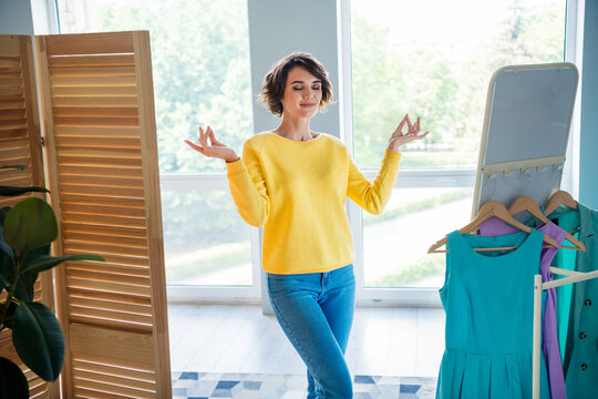 Photo of calm peaceful lady look mirror meditating try practice for loving herself in any appearance in modern dressing room