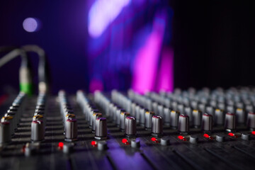 Sound mixer. Professional audio mixing console with lights, buttons, faders and sliders.