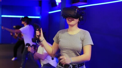 teenager in virtual reality glasses with joystick play survival game in tone jungle of future. High quality 4k footage