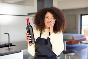 pretty afro black woman feeling bored, frustrated and sleepy after a tiresome. wine bottle concept