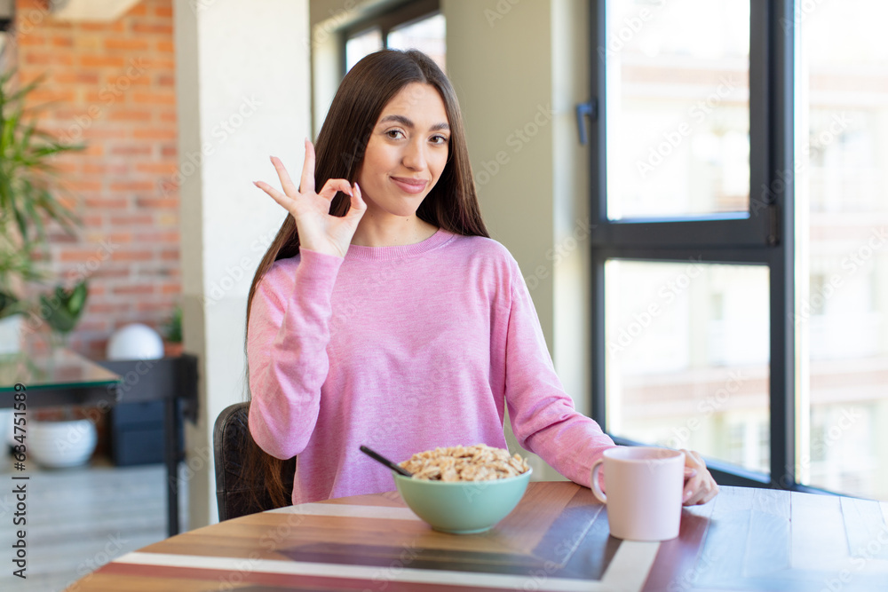 Poster feeling happy, showing approval with okay gesture. breakfast concept