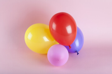balloons in harmonious colors on a pink background