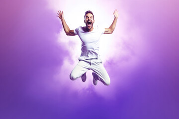 Fototapeta na wymiar Beautiful Happy Man Jumping On Purple Background. Happy Man, Purple Background, Beautiful, Jumping, Style, Smile, Pose, Creativity
