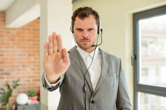 looking serious showing open palm making stop gesture. telemarketer concept