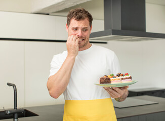 feeling scared, worried or angry and looking to the side. home made cakes concept