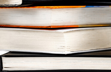 Closeup of book stack in the library room. Business and education concept.