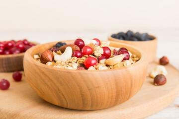 Cooking a wholesome breakfast. Granola with Various dried fruits and nuts in a bowl. The concept of a healthy dessert. Flat lay, top view with copy space