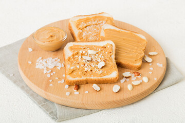 Peanut butter sandwiches or toasts on light table background.Breakfast. Vegetarian food. American cuisine top view vith copy space