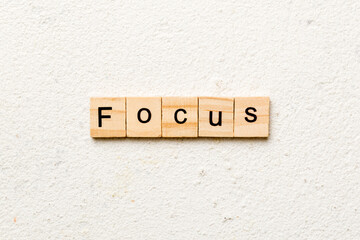 focus word written on wood block. focus text on table, concept