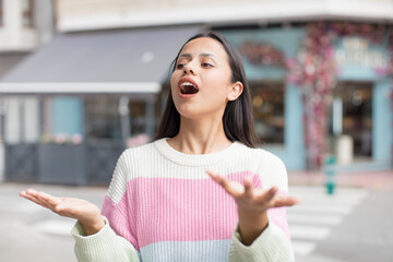 pretty hispanic woman performing opera or singing at a concert or show, feeling romantic, artistic...