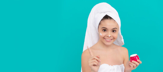 Close up face of kid girl, facial treatment, happy teen girl in bath tower applying body cosmetic, cosmetic. Cosmetics and skin care for teenager child, poster design. Beauty kid girl banner.