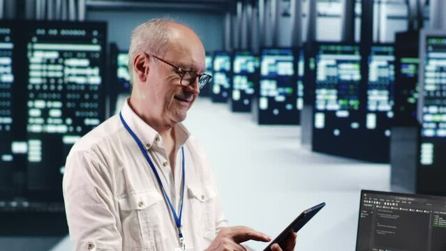 Meticulous computer scientist in data center, solving tasks on tablet while running scripts on laptop terminal. Precise admin amidst servers, accessing databases and manipulating lines of code