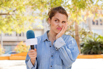 young pretty woman feeling bored, frustrated and sleepy after a tiresome. presenter and microphone...
