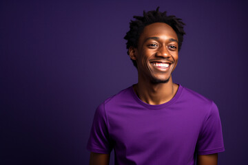 a happy man dressed in purple t shirt is smiling against a background