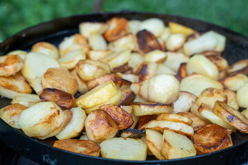 frying potatoes in a skillet , Close-Up Of Fried Potatoes In A Frying Pan.
