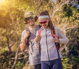Happy young couple traveling in the jungle forest near the ocean
