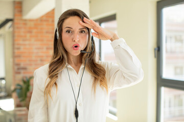 pretty woman looking happy, astonished and surprised. telemarketer concept