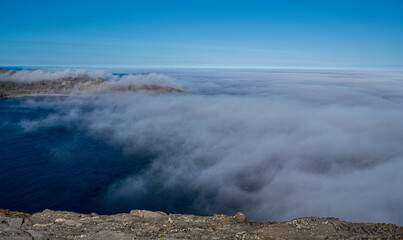 Beautiful view from the North Cape of the rocky cliffs and blue water of partly cloudy Barents Sea
