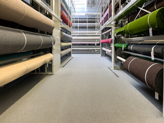 Carpet store. Carpets rolled up. Large assortment of carpets.