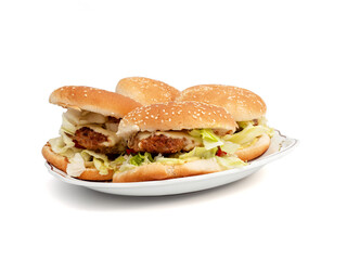 Homemade hamburger on a white background. Delicious burger with cheese, bacon, onion, cucumber, tomato and lettuce on a white background.