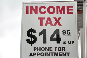 income tax 14 95 15 dollars and up phone for appointment vertical rectangle high hanging sign with...
