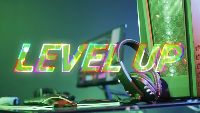 Animation of level up text over video game equipment on neon background