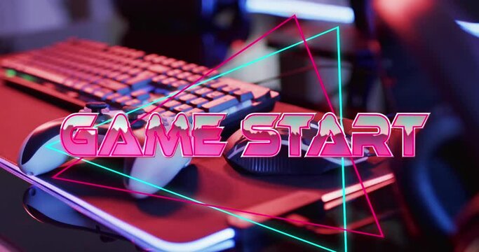 Animation of game start text, computer video game equipment on neon background
