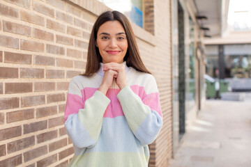 pretty young adult woman happy and excited, surprised and amazed, giggling with a cute expression