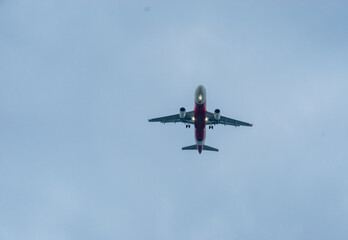 Commercial passenger airplane jet on final approach coming in for landing at the airport.