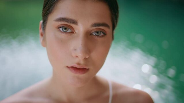 Portrait woman looking camera blue lagoon. Girl face posing nature seductively