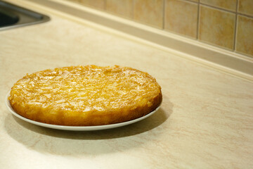 Pineapple pie on the plate in the kitchen table.