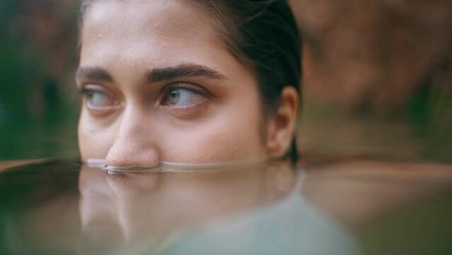 Lady eyes peeping lake surface summer nature closeup. Clear sight woman swimming