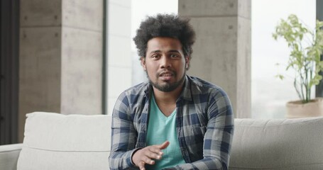 Young black man blogger talks speaks. Man speaks, gesticulates, explaining, talking. Black man teacher coach blogger offers online lessons. Multiethnic broadcaster shares his thoughts via webcam.