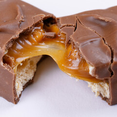 Sweet chocolate bar broken into two pieces. Macro photo.