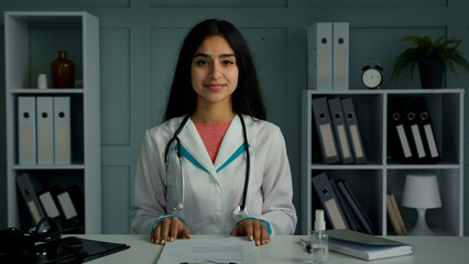 Professional young doctor arabian indian woman physician provide remote medical assistance in...