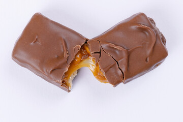 Chocolate bar with caramel fillings. Sweet chocolate bar broken into two pieces. Top view.