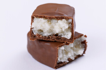 Chocolate bar with coconut filling. Sweet chocolate bar broken into two pieces. Macro.