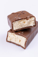 Chocolate bar with filling. Sweet chocolate bar broken into two pieces. Macro.