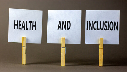 Health and inclusion symbol. Concept words Health and inclusion on beautiful white paper on clothespin. Beautiful grey background. Business motivational health and inclusion concept. Copy space.