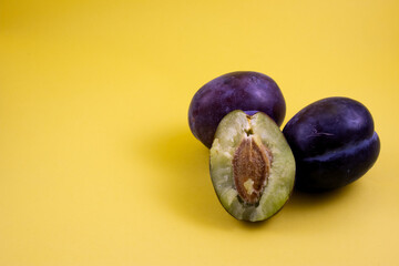 plums on a wooden board